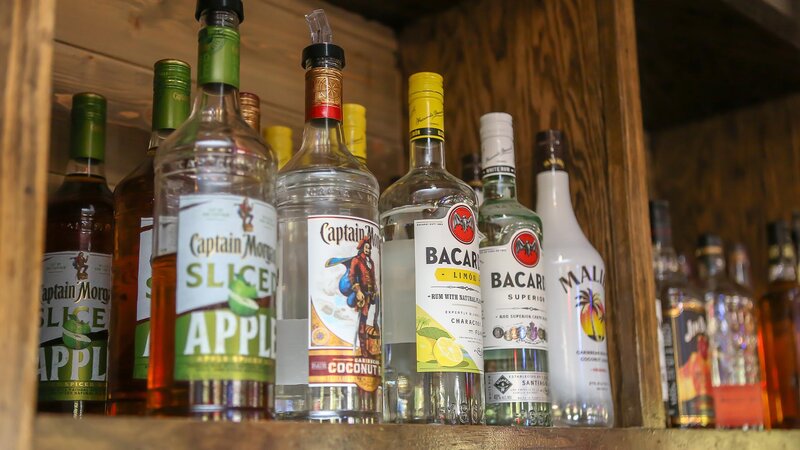 Many bottles of clear liquor at the bar